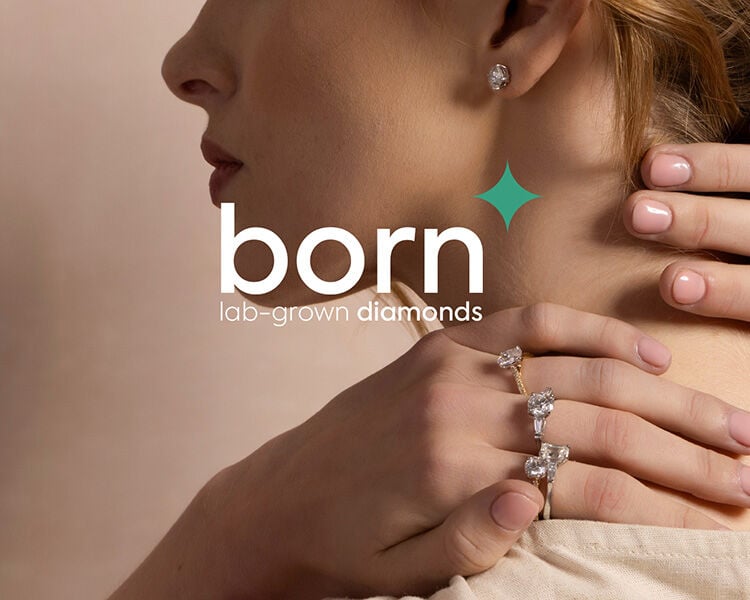 Woman wearing Born lab-grown diamond engagement rings and earrings, sustainable fine jewellery collection